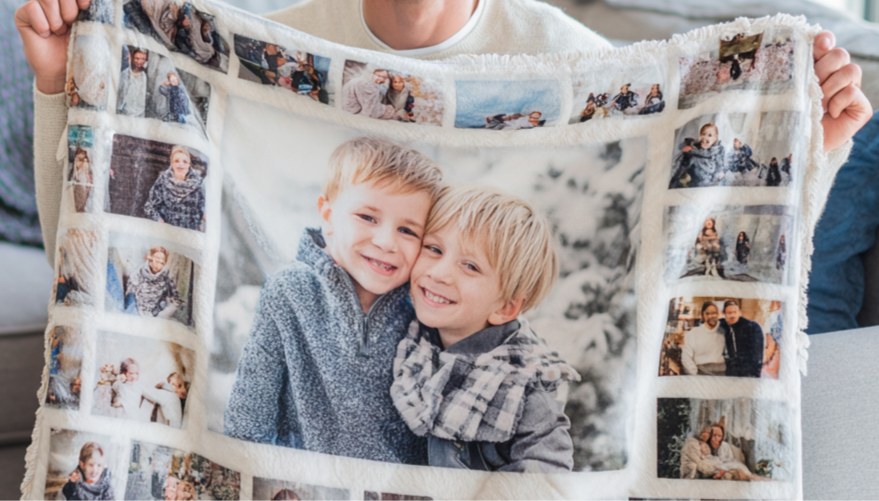 Person holding a blanket with multiple photos of children on it